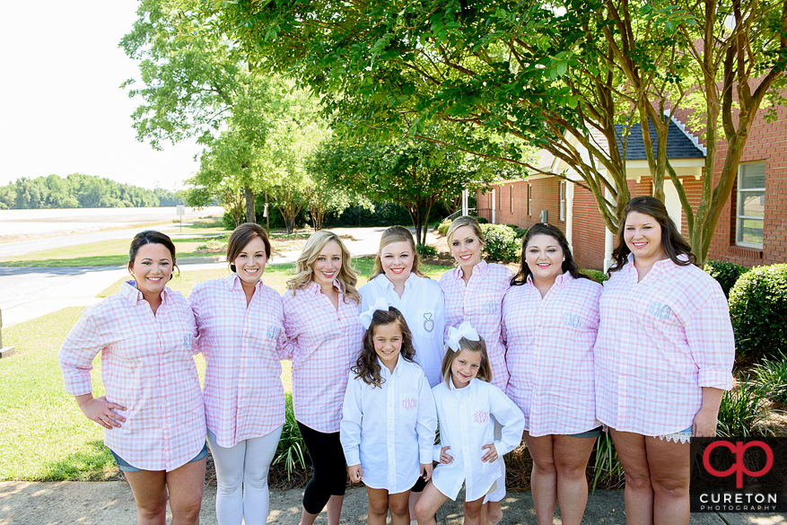 Bride and her bridesmaids in matching embroidered shorts pre-wedding.