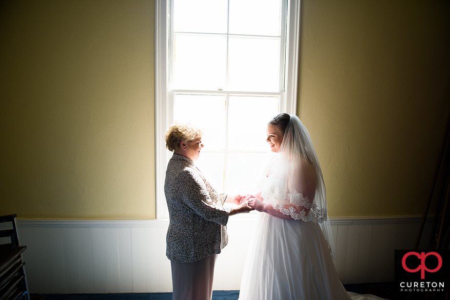 Bride putting on her wedding dress.