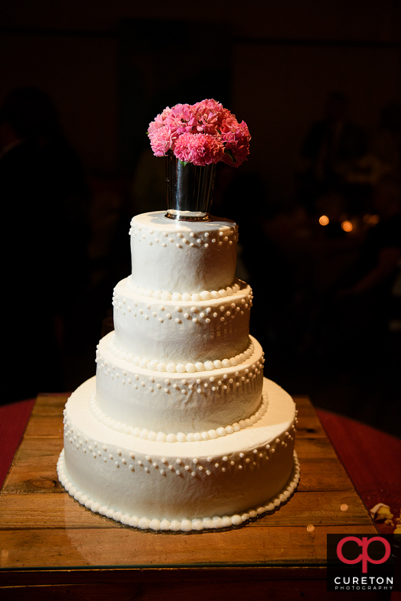 Bride and groom cutting the cake.