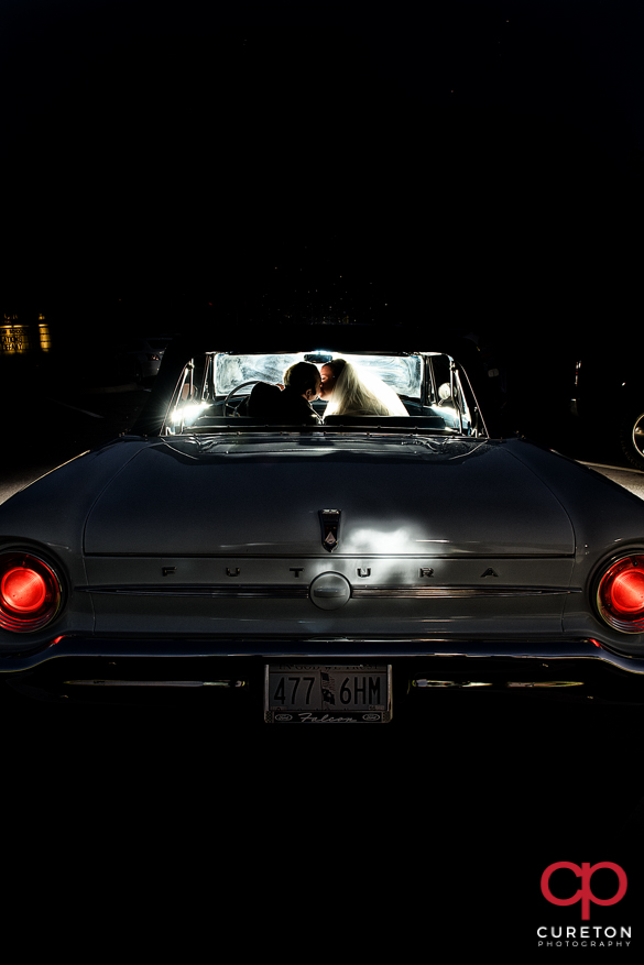 Bride and groom leaving in a vintage car from their Sumter,SC wedding.