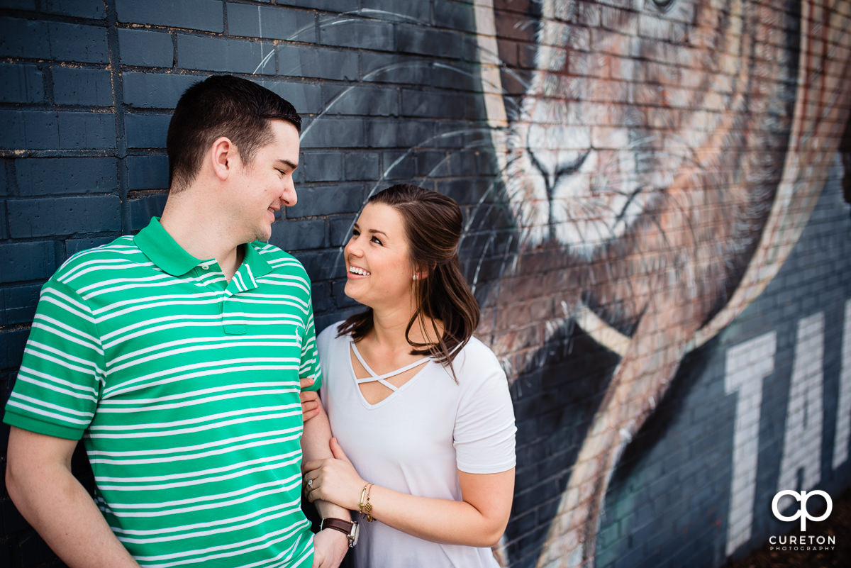 Future bride and groom outside of the Swamp Rabbit Brewery for their engagement session.
