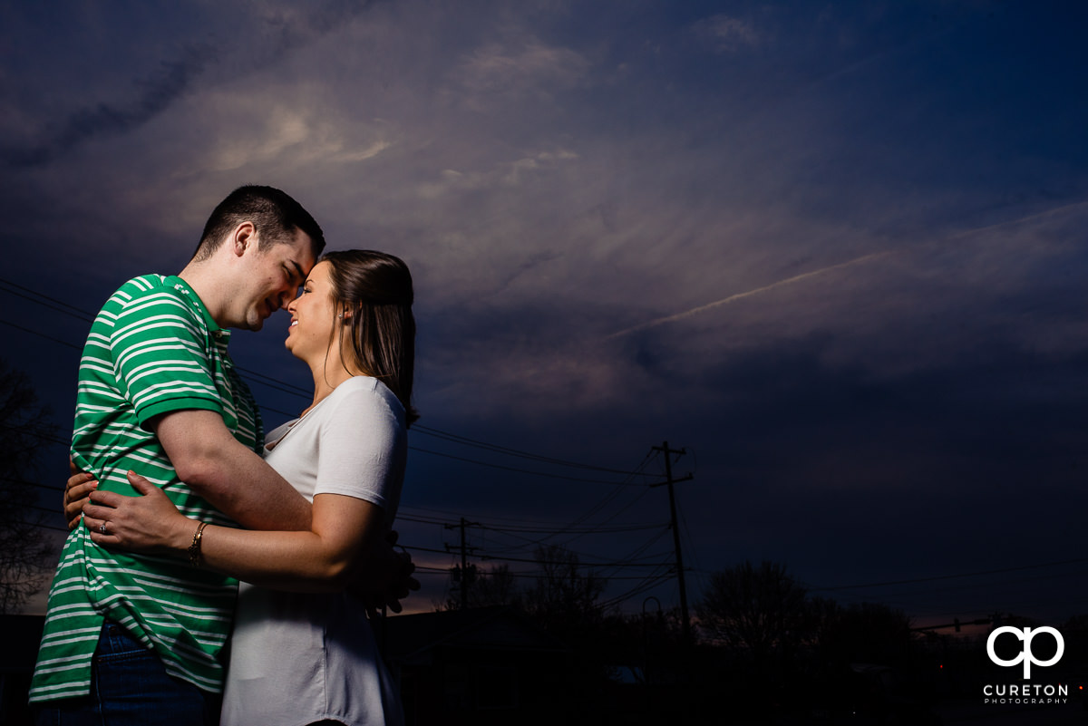Bride and groom outside the Swamp Rabbit Brewery and Taproom during sunset at their engagement session.
