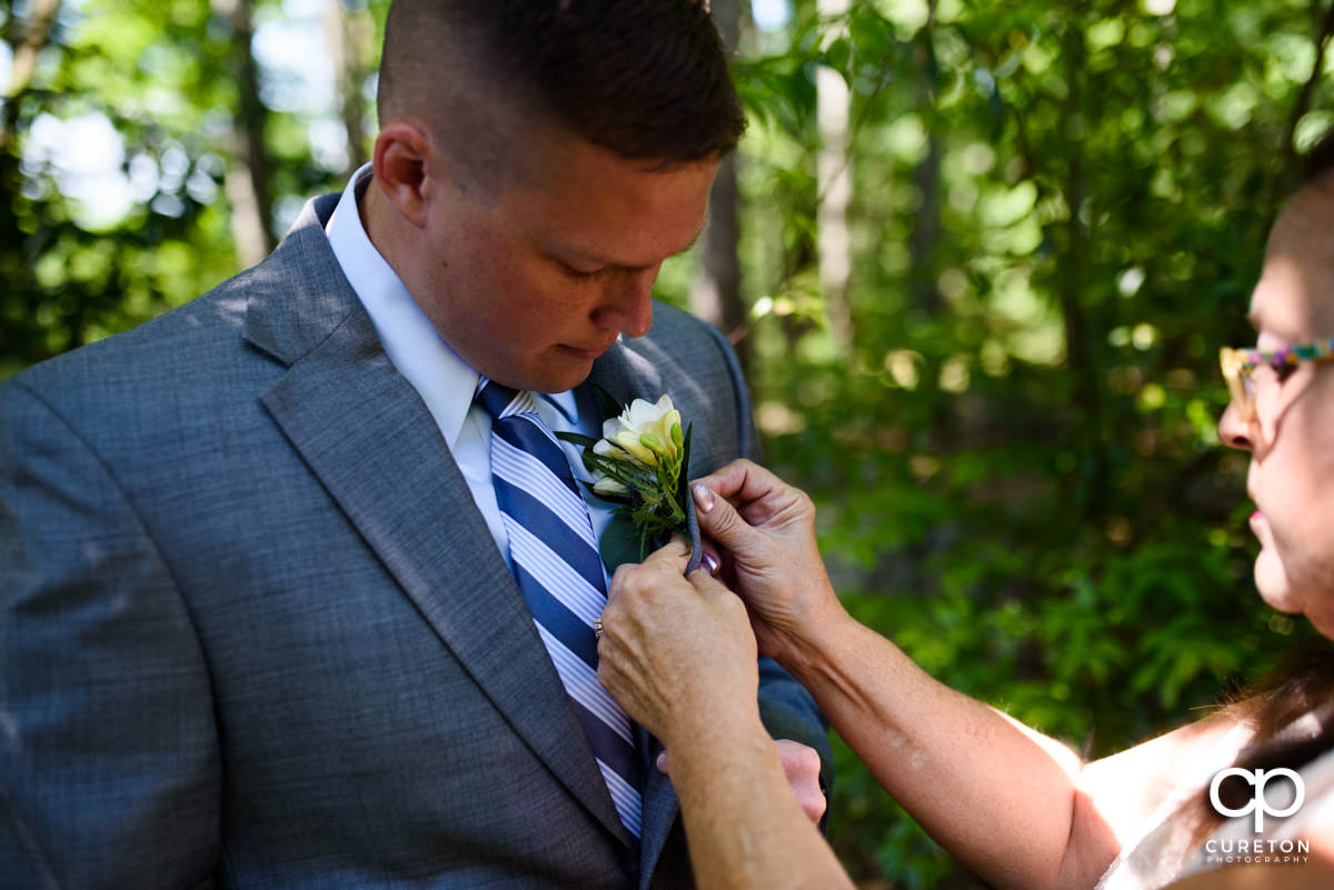 Groom getting his boutonnière on.
