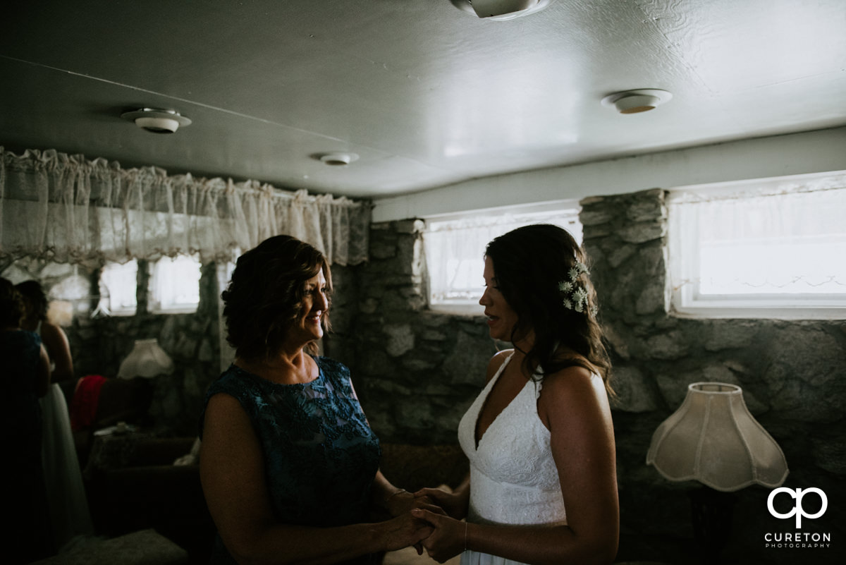 Bride and her mom sharing a moment before the ceremony.