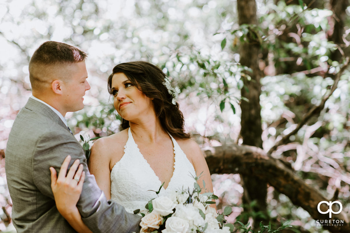 Bride looking at her groom in the forest after their elopement wedding in South Carolina.
