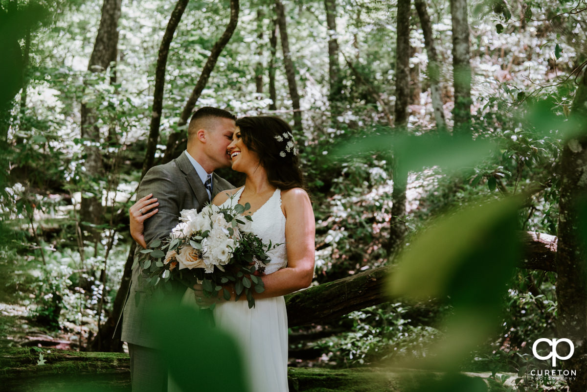 Bride and groom laughing in the woods after their South Carolina elopement wedding.