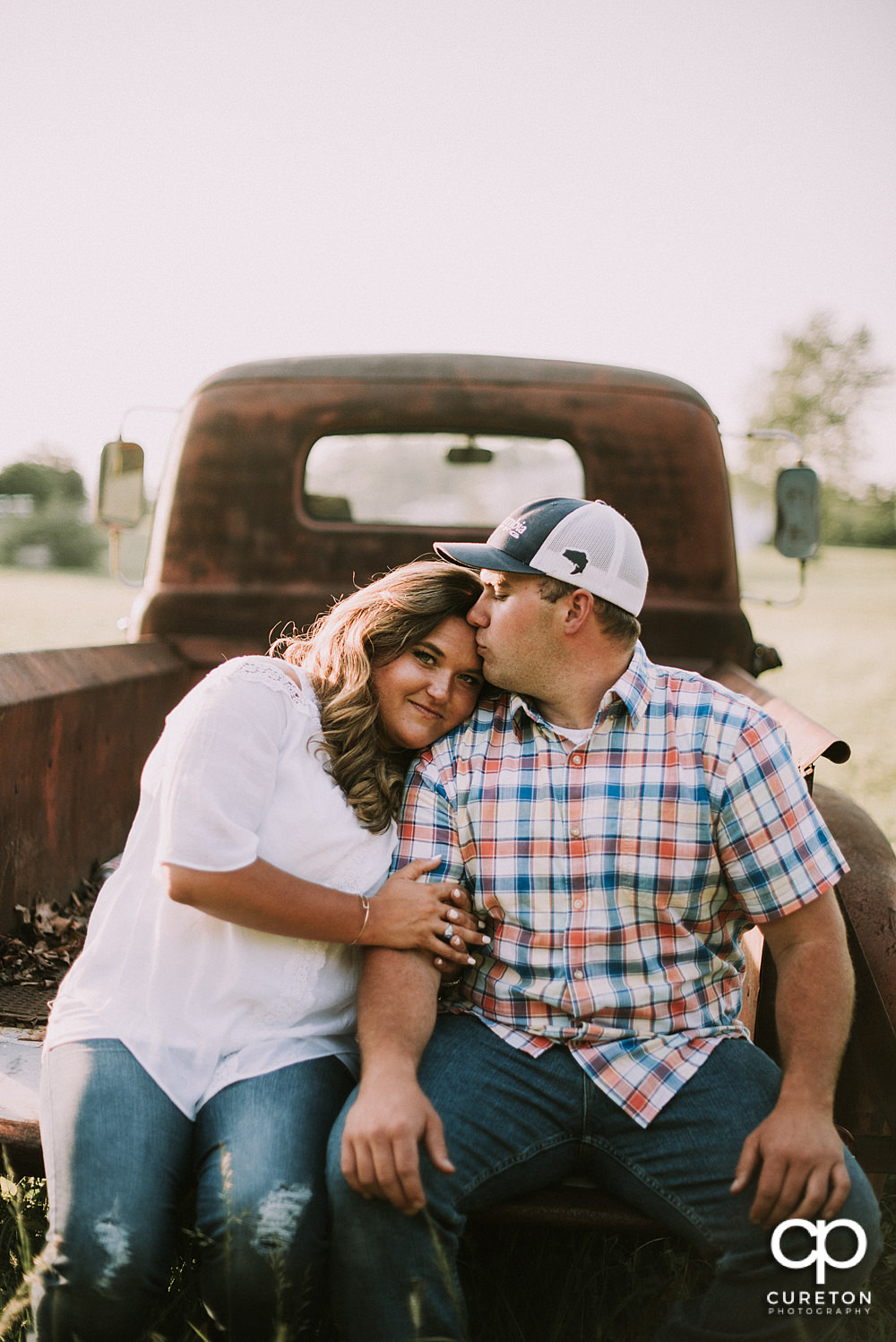 Groom kissing his bride during a Travelers Rest engagement session.