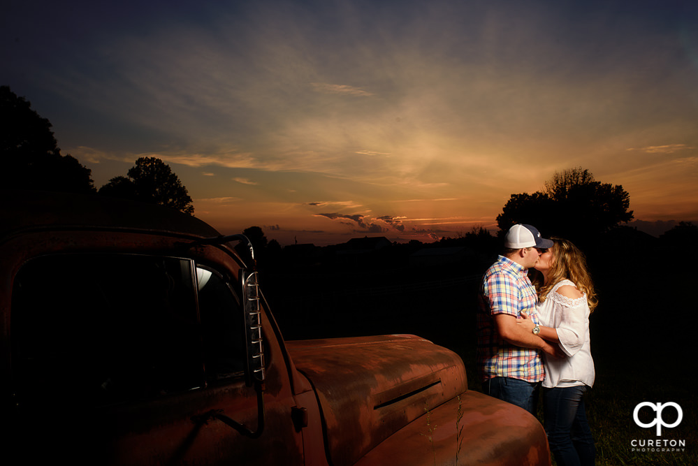 Bride and groom kissing at sunset during a Travelers Rest engagement session..
