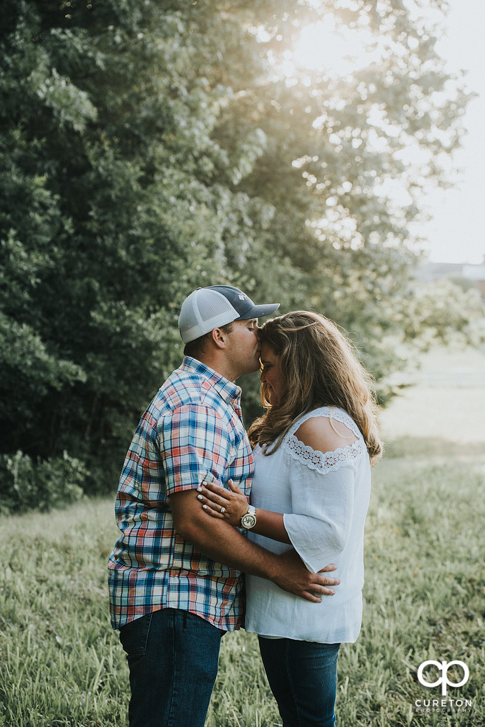 Engaged couple in a field during a Travelers Rest engagement session.
