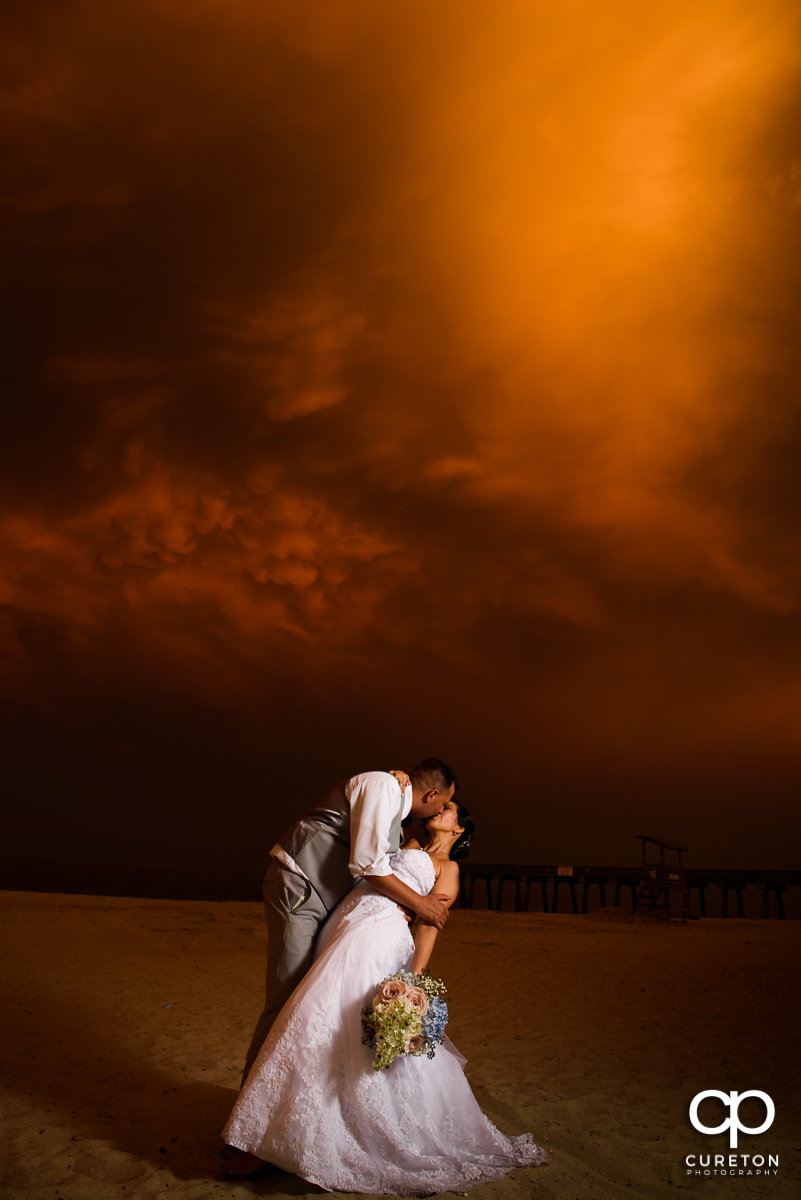 Bride and groom on the beach at sunset after their wedding at the Tybee Island Wedding Chapel in Georgia.