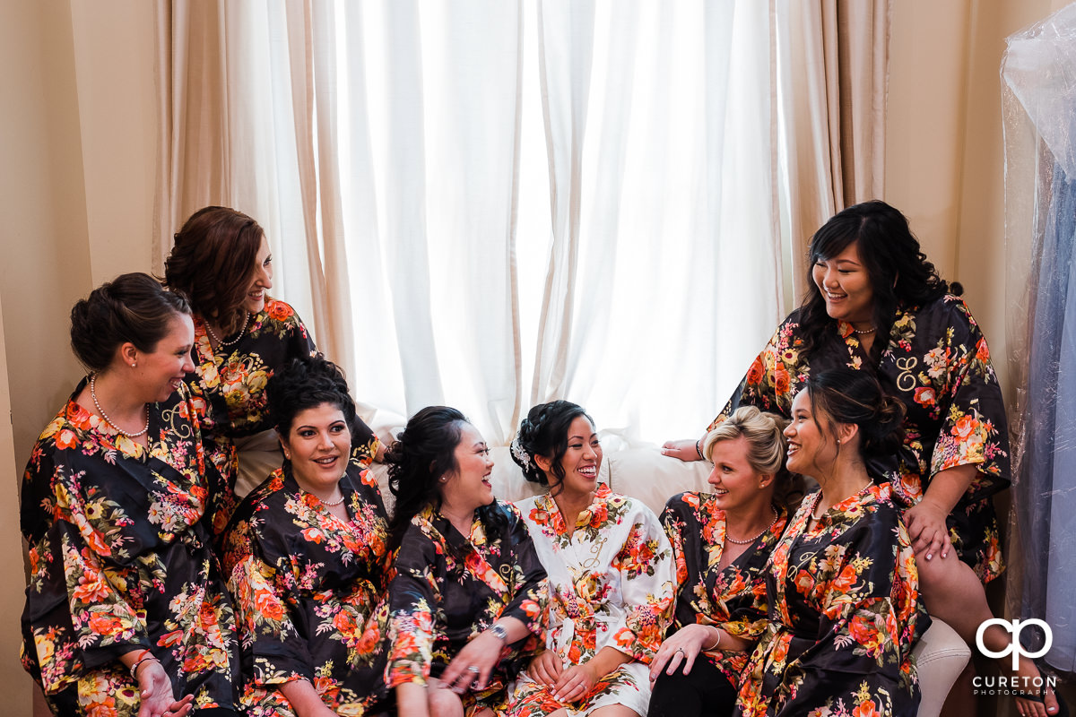 Bride and her bridesmaids in robes before the ceremony.