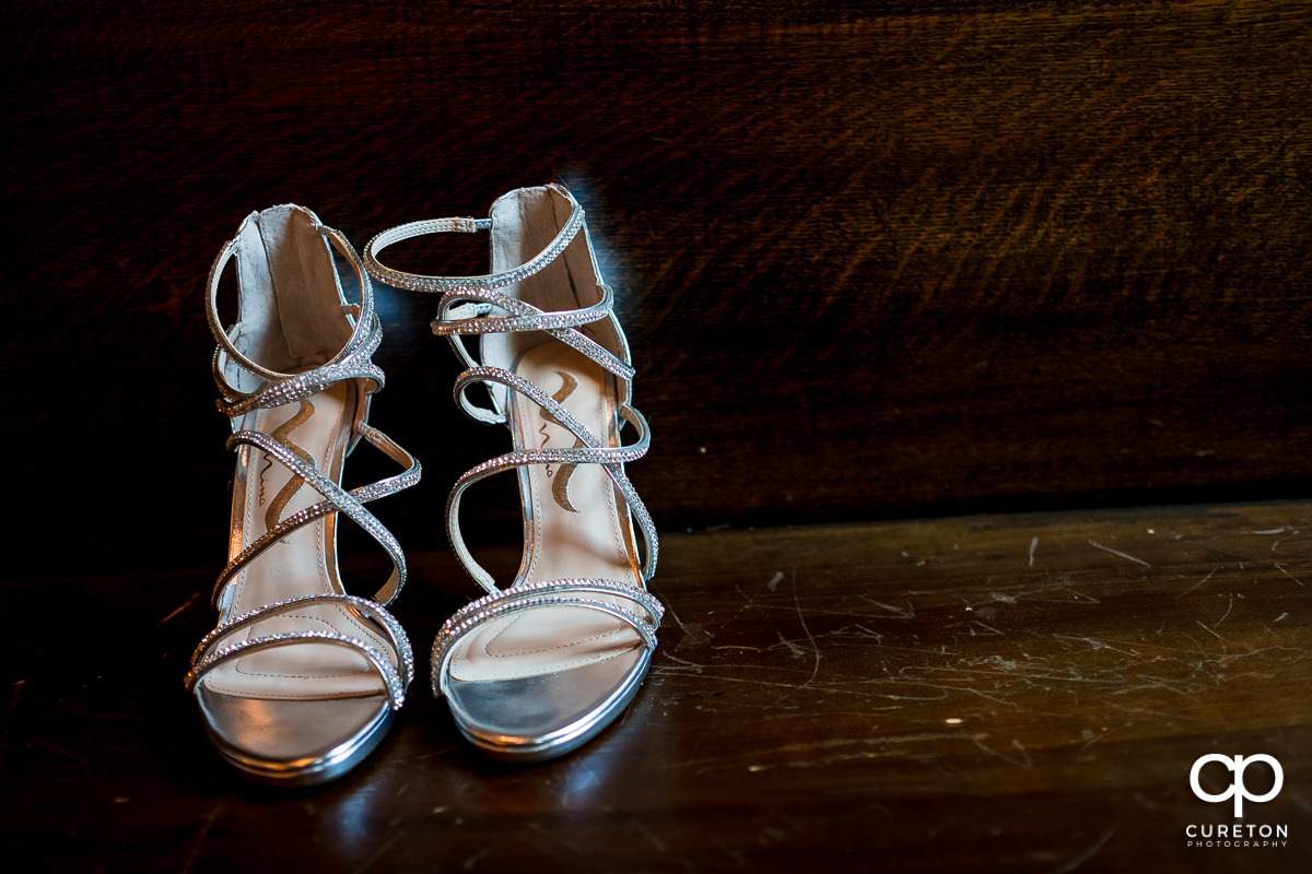 Bride's shoes on a pew.