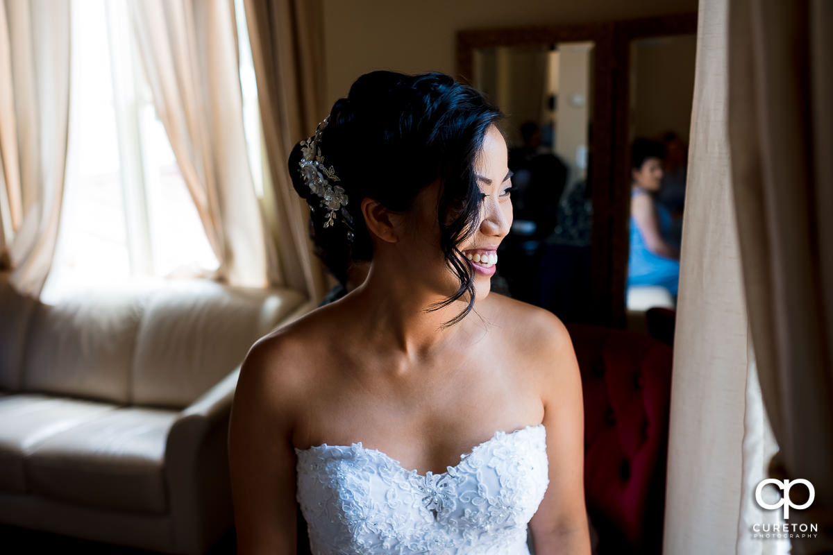 Bride looking out the window in the bridal suite at the Tybee Island Wedding Chapel.