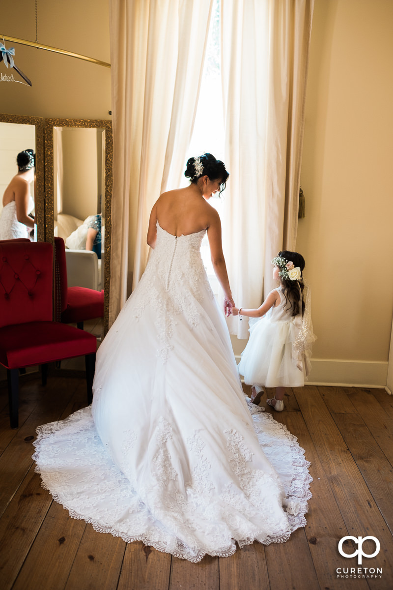Bride and her flower girl sharing a moment before the wedding ceremony.
