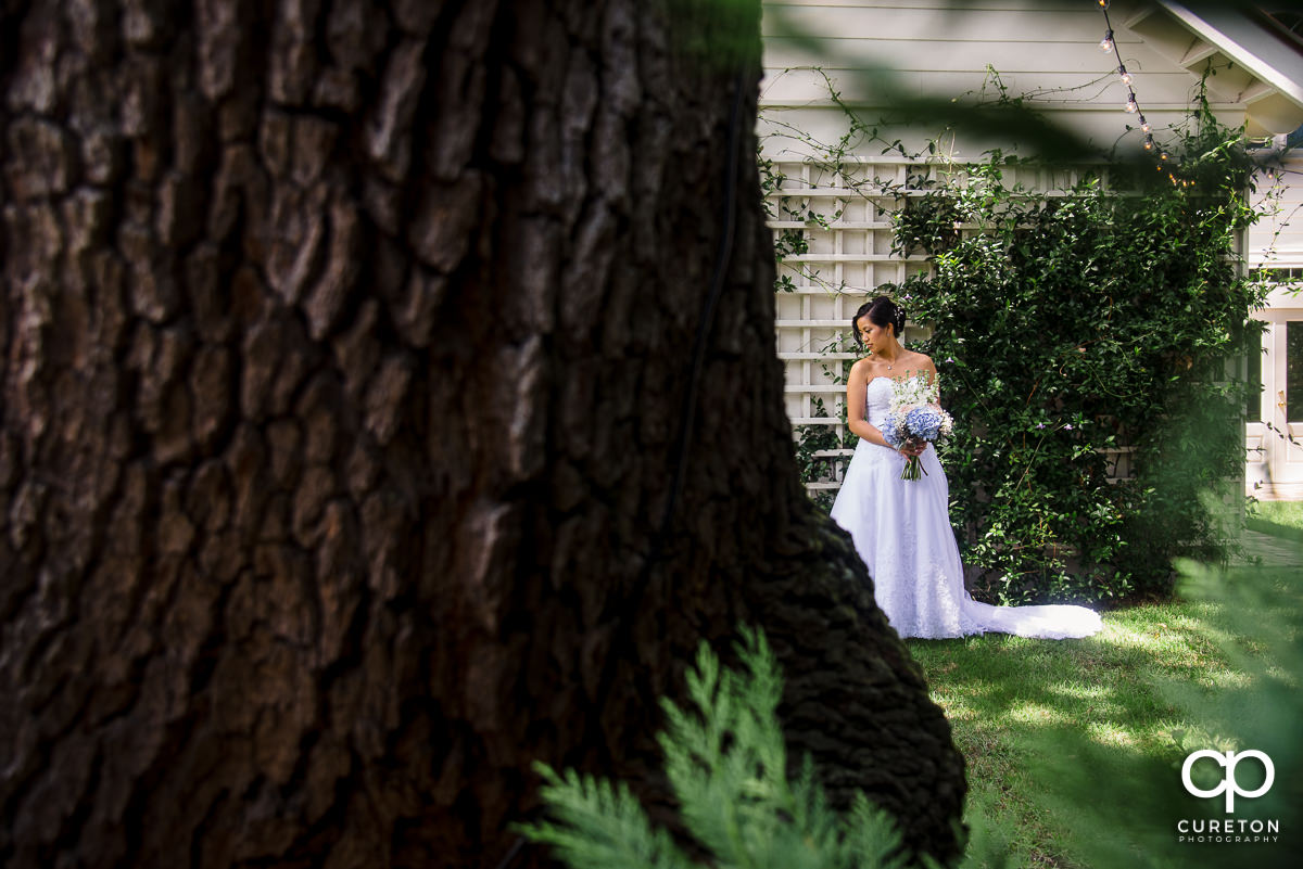Bride looking at her dress outside the Tybee Island Wedding Chapel.