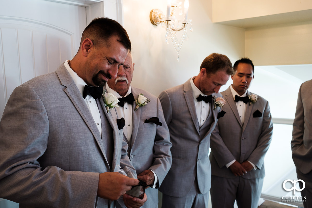 Groom receiving a gift before the wedding ceremony.