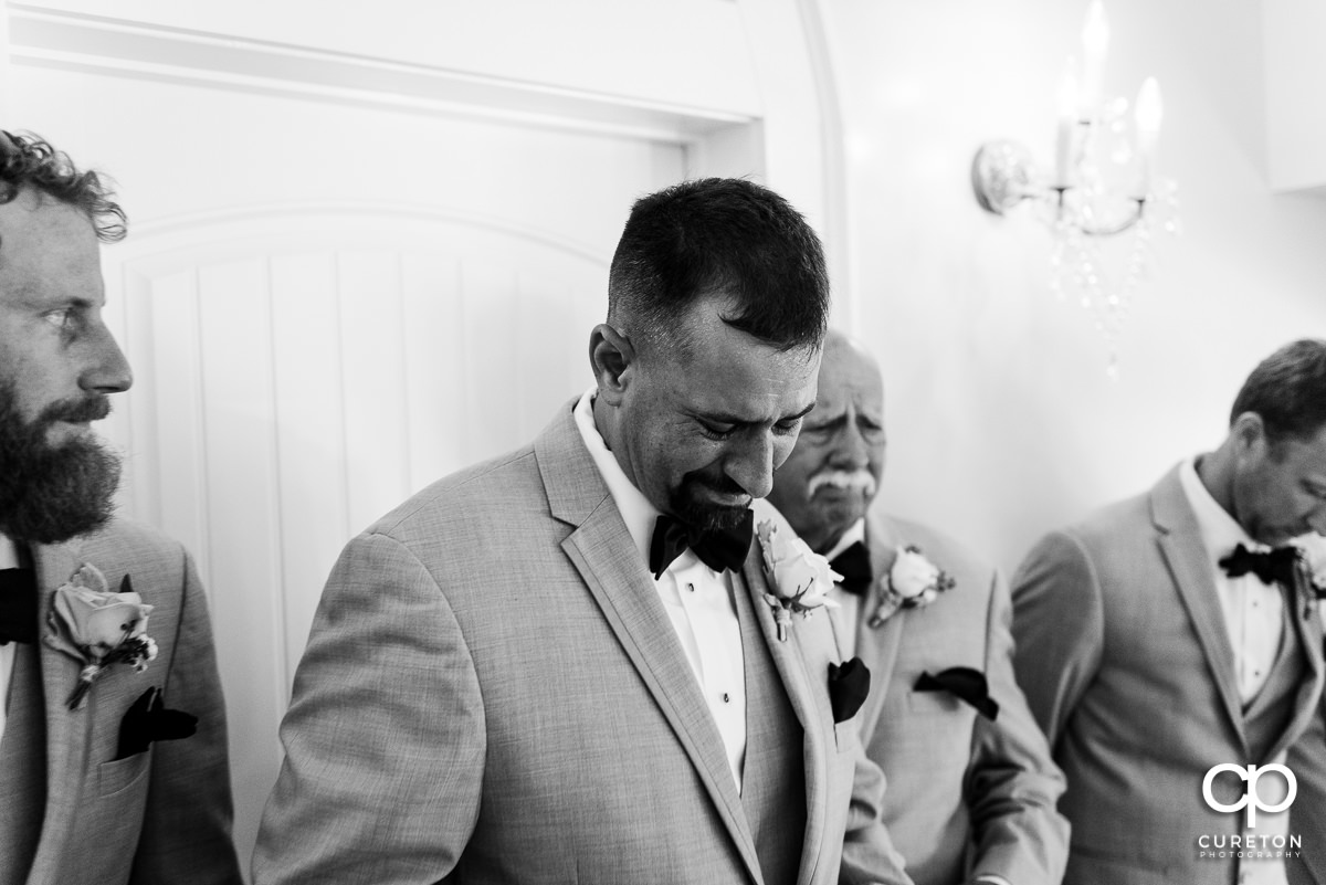 Groom getting emotional after receiving a gift before the wedding ceremony.
