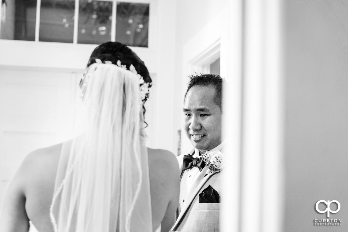 Bride's brother crying when he sees his sister in her dress for the first time.