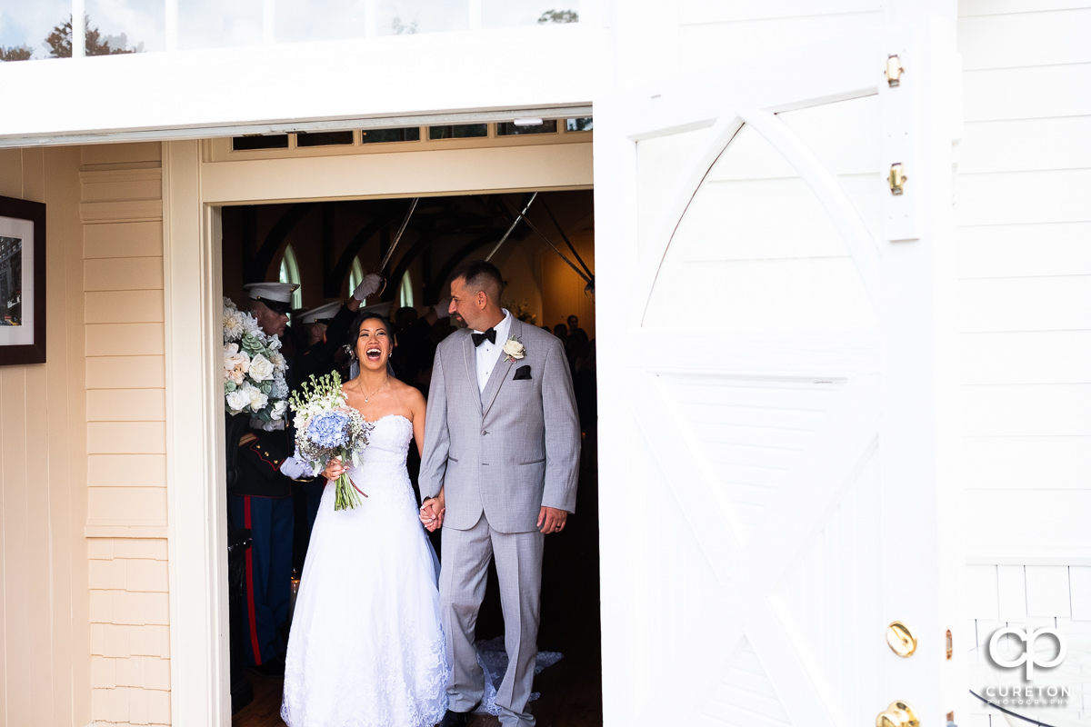 Bride and groom smiling leaving their Tybee Island wedding ceremony.