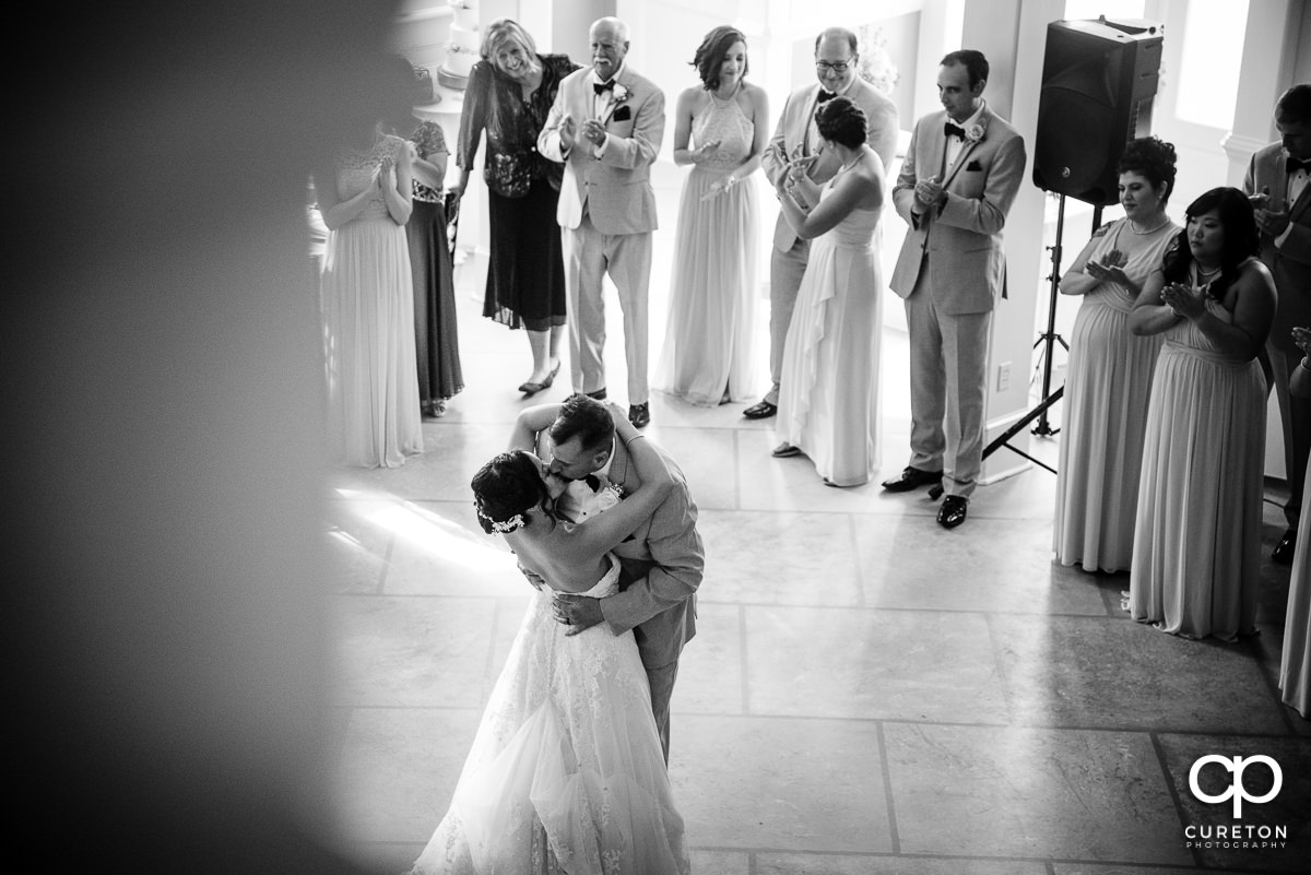 Groom kissing his bride after their first dance.
