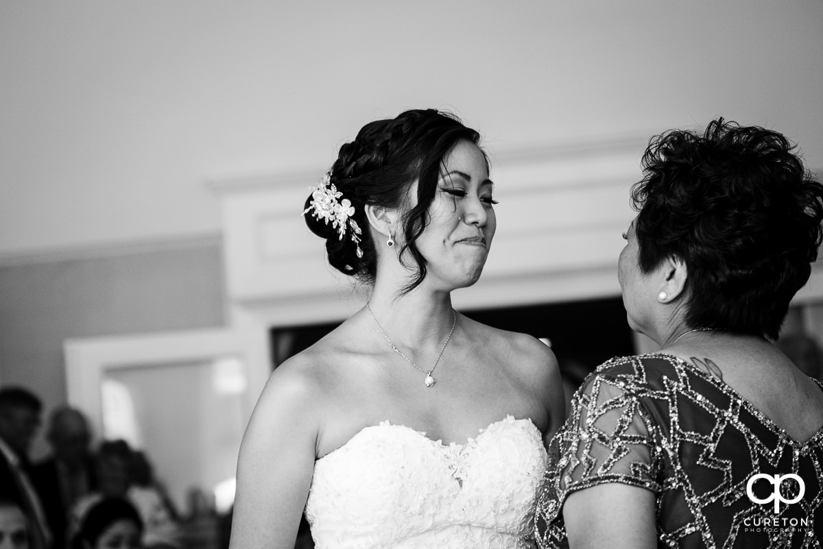 Bride tearing up during a dance with her mother at the wedding reception.