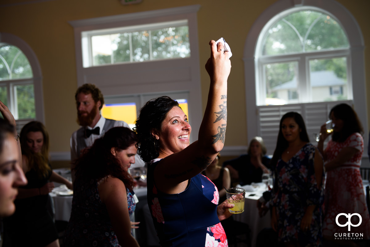 Wedding guest taking a selfie on the dance floor.