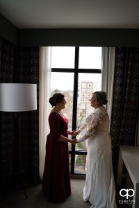 Bride having a moment with her mom before the wedding.