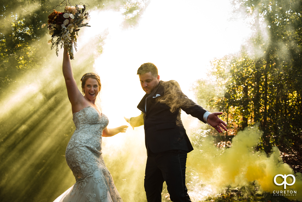 Bride and groom dancing in some yellow smoke at their Viewpoint at Buckhorn Creek wedding in Greenville,SC.