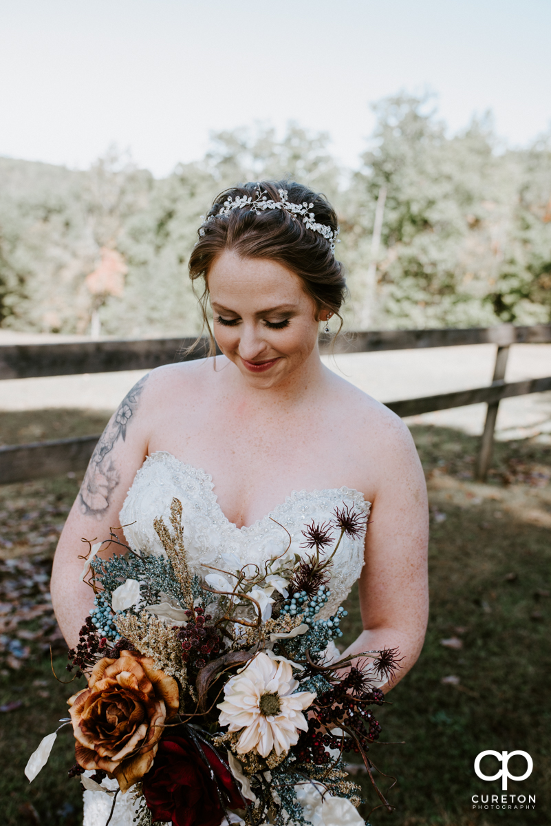 Bride holding her bouquet at the Viewpoint at Buckhorn creek.