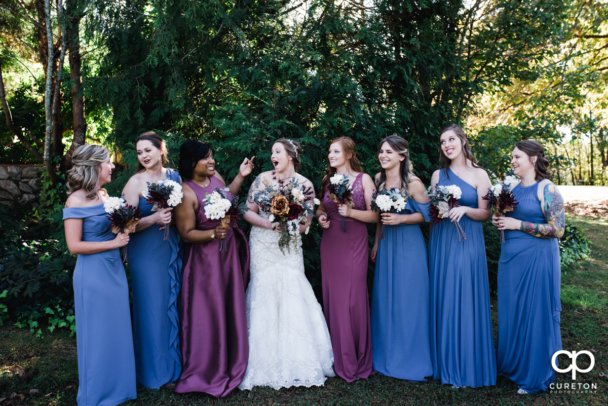 Bride laughing with her bridesmaids.