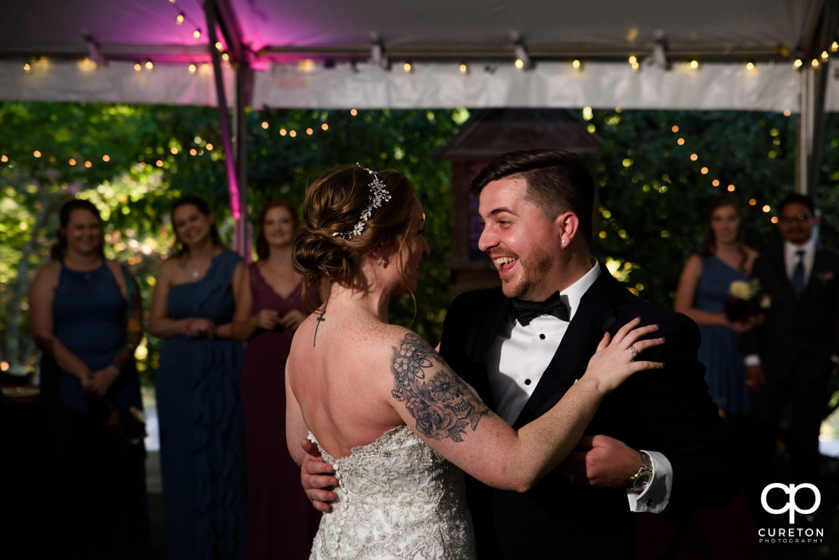 Bride and groom laughing during their first dance.
