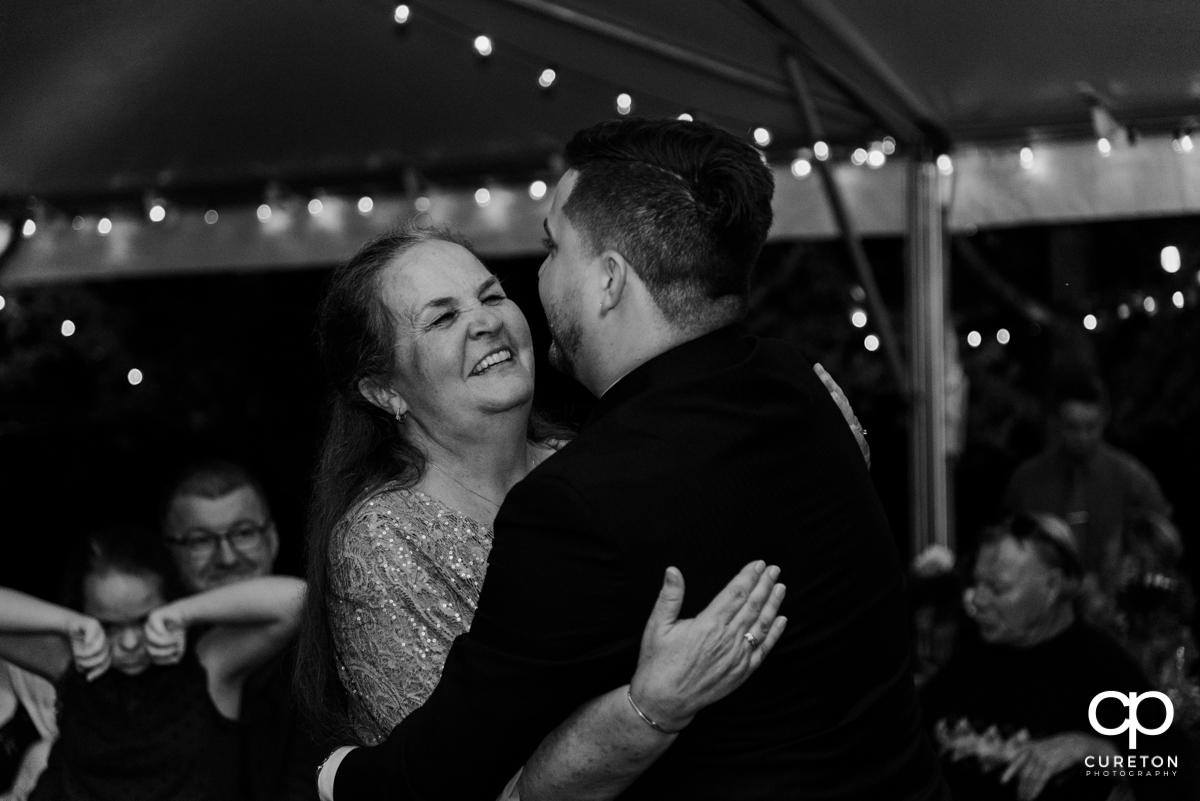 Groom's mom smiling at her son.