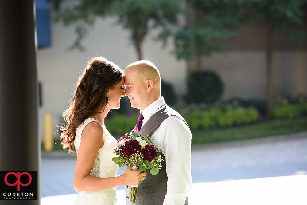 Bride and groom in front of the Hyatt Regency in downtown Greenville.