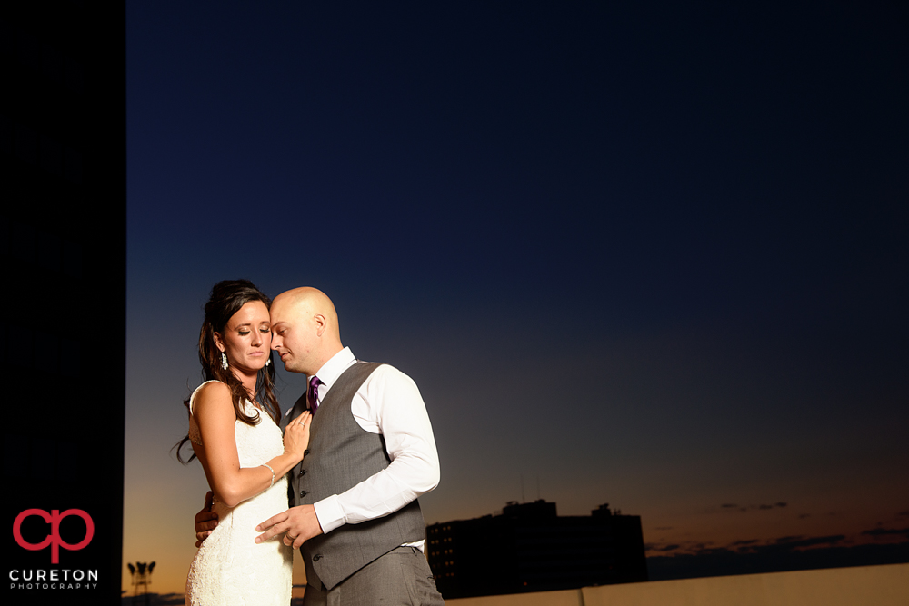 Bride and groom on the rooftop during their commerce club wedding at sunset.