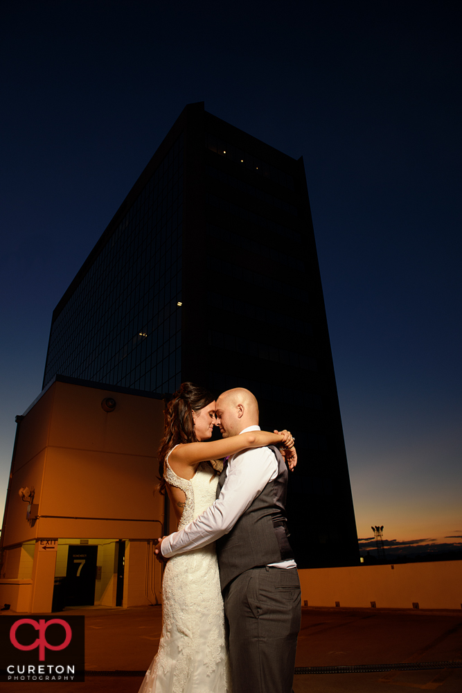 Bride and groom at sunset during their commerce club wedding reception in Greenville South Carolina.