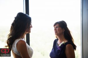 Mother of the bride crying when she sees her in the dress.