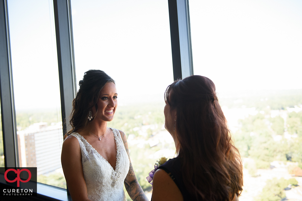 Bride and her mother are sharing a minute before her wedding.
