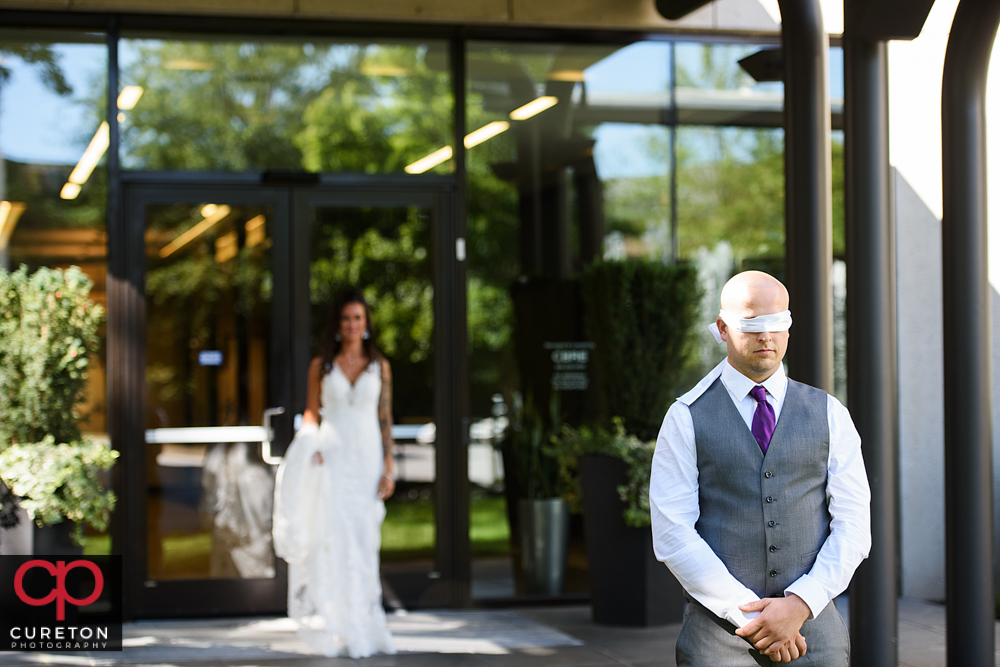 Groom blindfolded for the first look.