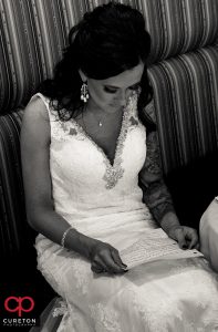 Bride reading a letter from the groom.