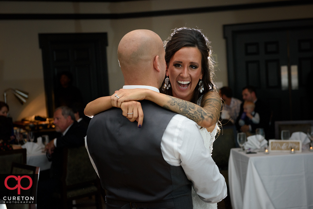 Bride laughing during their first dance.