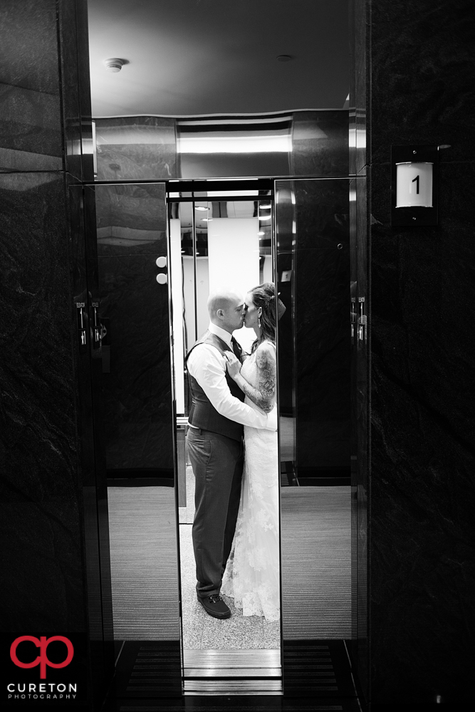 Bride and groom in the elevator at the commerce club.