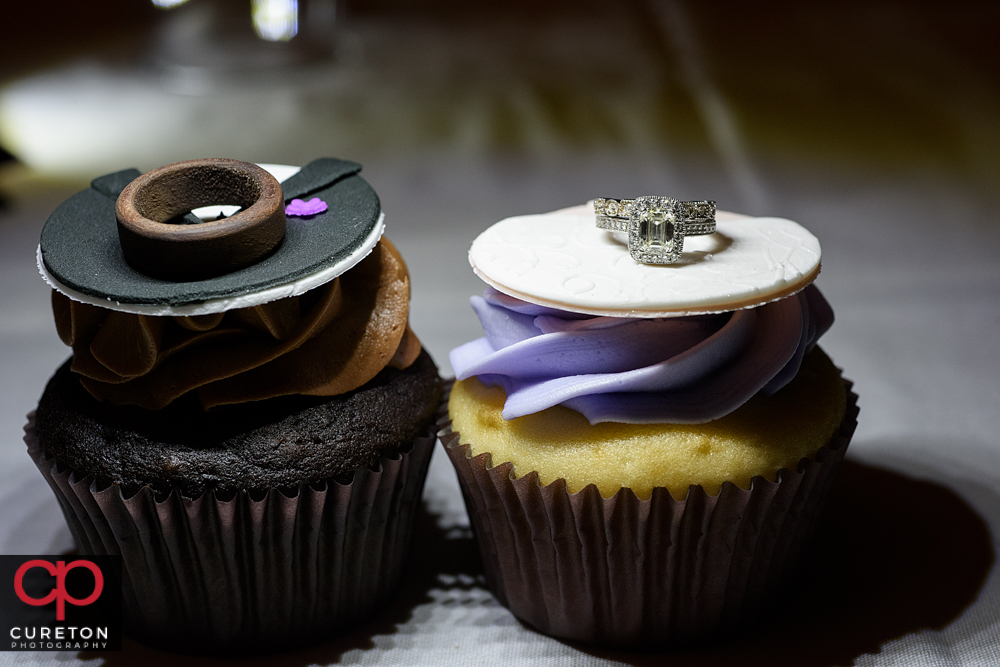 Wedding rings sitting on top of cupcakes from buttercream bakehouse.