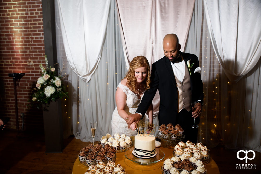 Bride and groom cutting the cake from Buttercream Bakehouse in Greenville,SC.