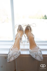 Bride's shoes in a window.