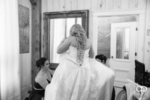 Bride putting a dress on.