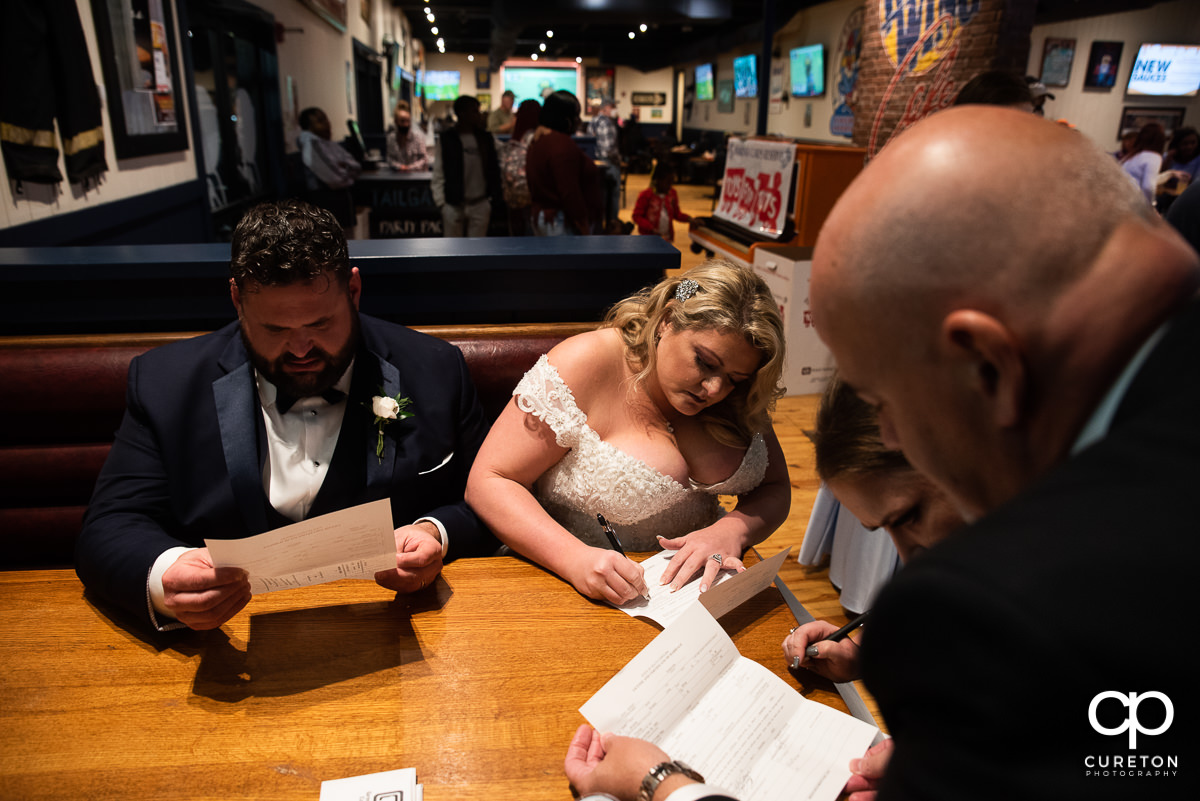 Bride and groom in a booth at Wild Wings.