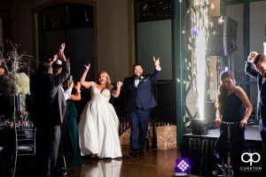 Bride and groom making an entrance into the wedding reception with spark fountains.
