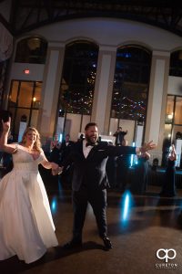 Bride and groom dancing into the reception.