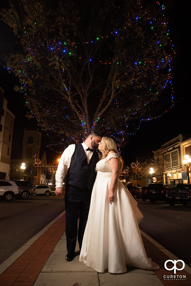 Bride and groom kissing on the street in downtown Anderson,SC.