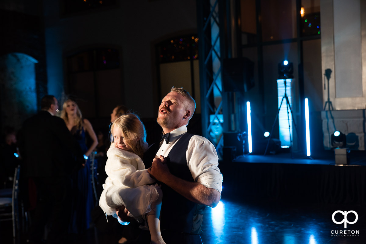 Groomsmen dancing with his daughter.